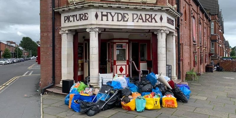 Hyde Park Picture House with bags of unwanted items for donation in front