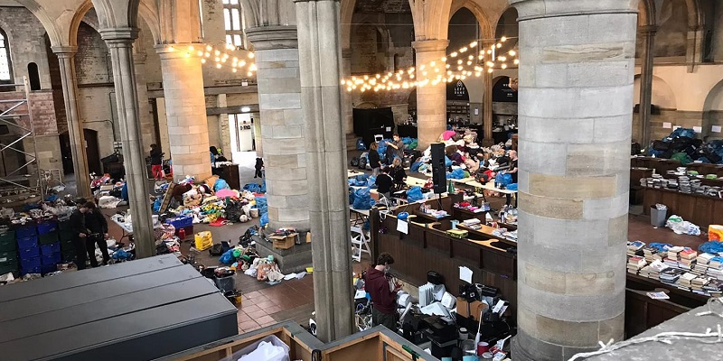 Left bank leeds big hall space with piles of items to be sorted