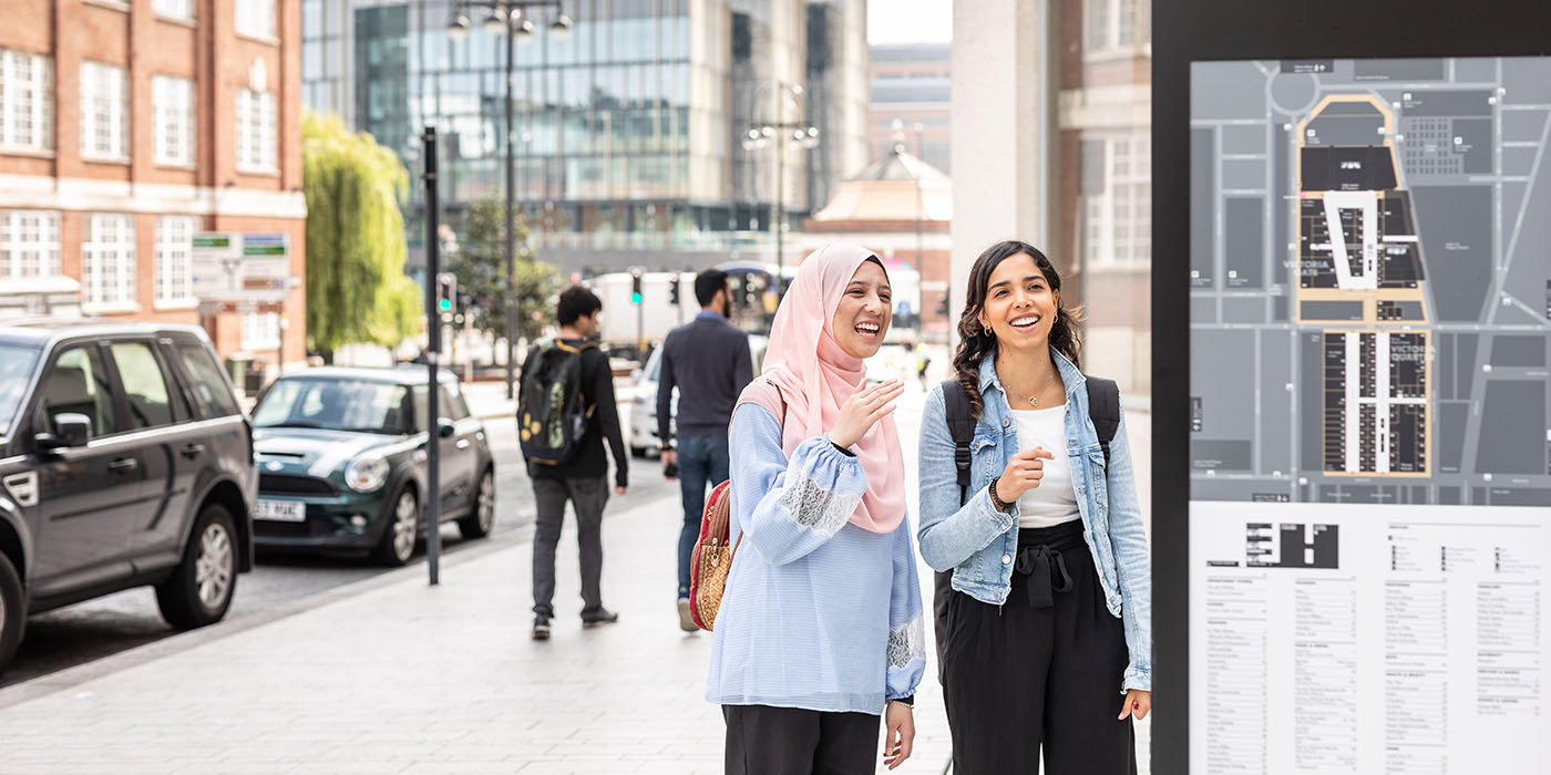 Two students looking at a map in Leeds City Centre
