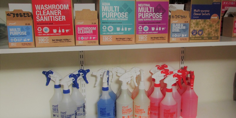 two shelves, one iwht reusable claning bottles and one with soluble tablets in boxes