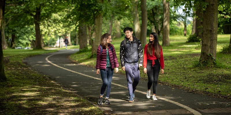 three people walking in the park