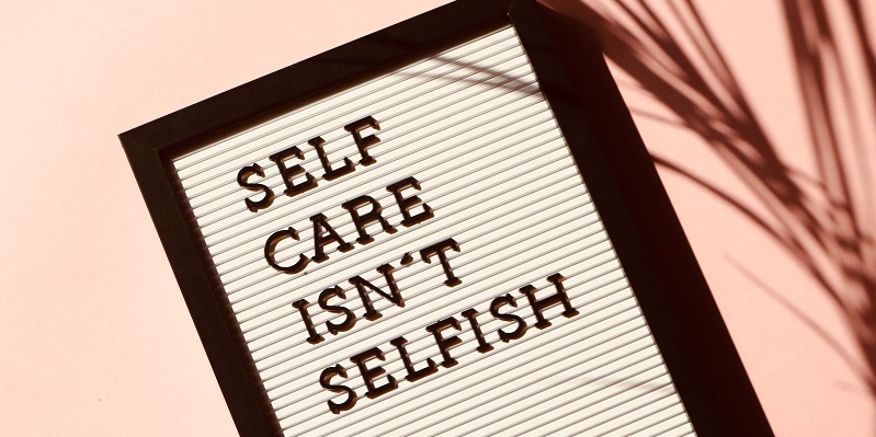 noteboard with the words 'self care isn't selfish' on it