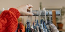 A photograph of a clothes rail with second hand clothes on