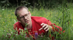 Student Seb Stroud in a meadow area on campus