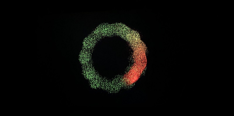 Black background with a ring of red and green lights in the centre
