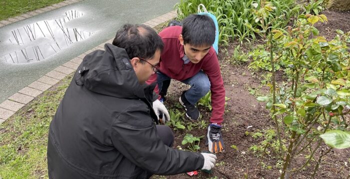 A photo of staff and students planting food to grow on campus in our community food growing space