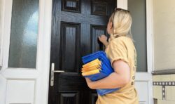 Woman holding blue bags and leaflets knocking on a door