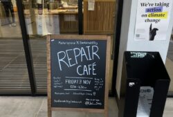 A blackboard with the words 'Repair Cafe' written on