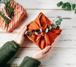 A gift wrapped in orange material rather than paper