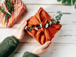 A gift wrapped in orange material rather than paper