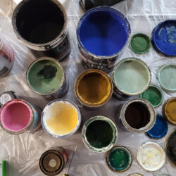 An assortment of paint pots of various colours.