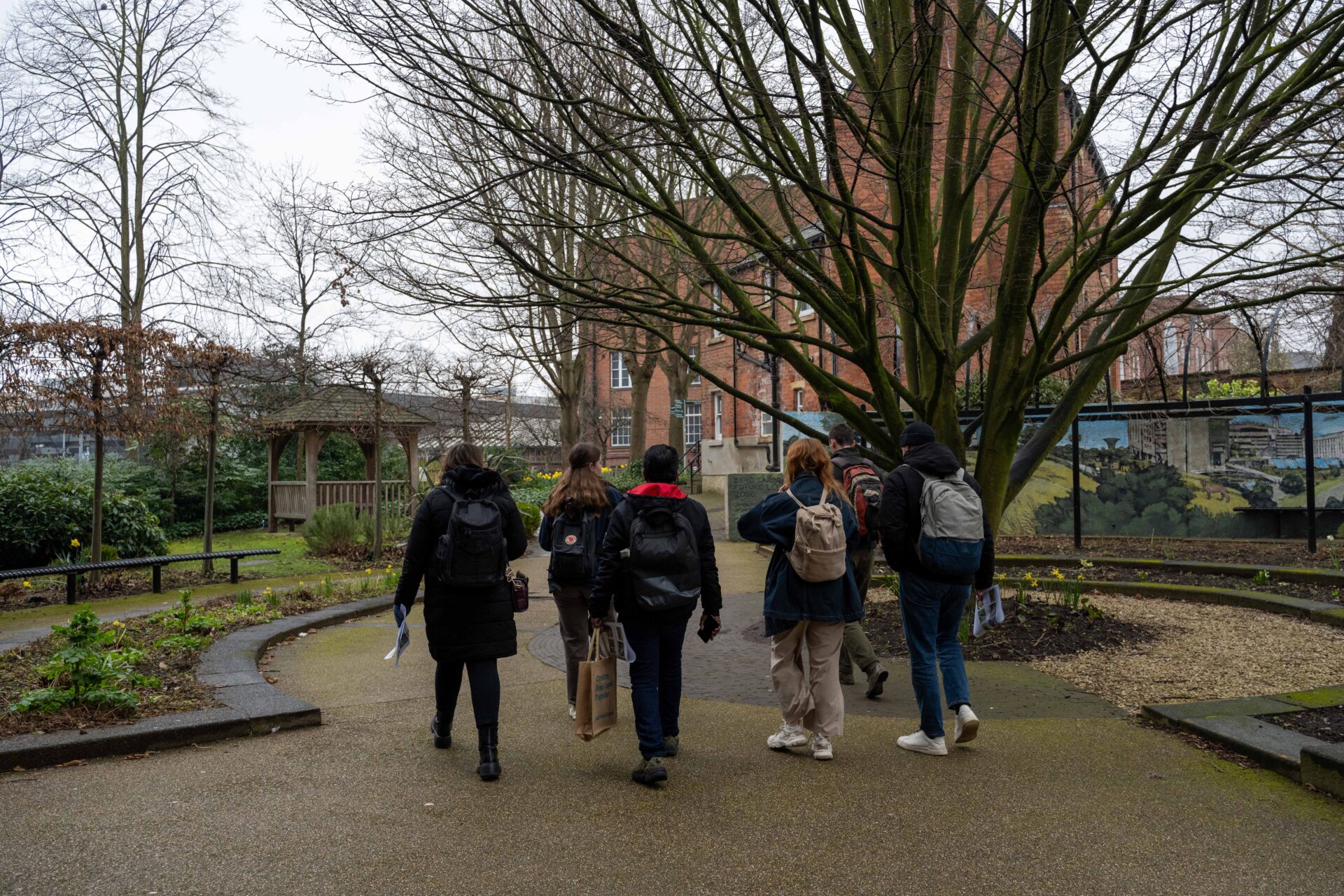 A group of staff and students observing nature outside the entrance to Edward Boyle Library