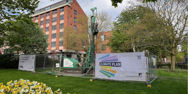 A drilling rig surrounded by metal fencing in front of Henry Price hall of residence.