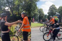 A training instructor teaching a group of people how to cycle